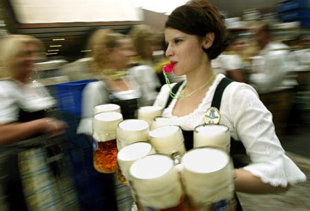 Beautiful waitress, traditional dress, loud whistle and a load of beersteins, Oktoberfest beer festival, Munich, September 21, 2002.